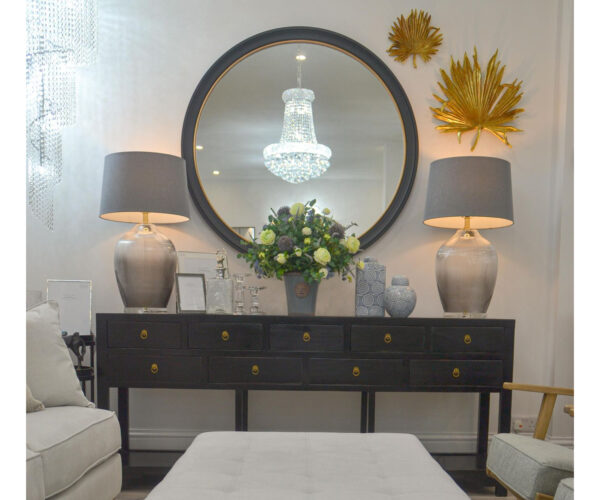 EX-DISPLAY - Black 9 Drawer Console, Black Round Mirror, 2 Grey Glass  Lamps and Flower Arrangement in Ceramic Pot